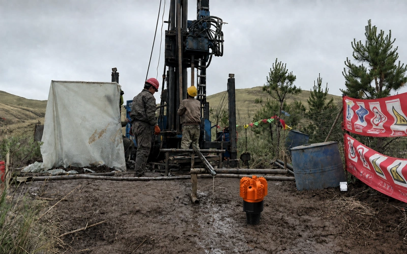 PDC drill bit in action at a drilling construction site for water well or mining project